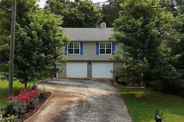 5624 Ryan Way, Flowery Branch, GA 30542 - view of front of property featuring concrete driveway, a garage, a front lawn, and a chimney