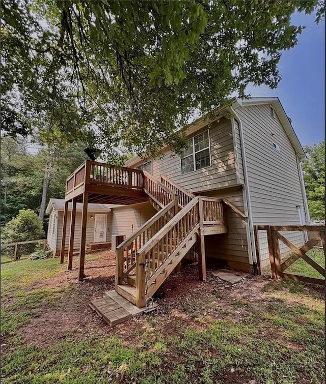5624 Ryan Way, Flowery Branch, GA 30542 - rear view of house with stairs and a wooden deck