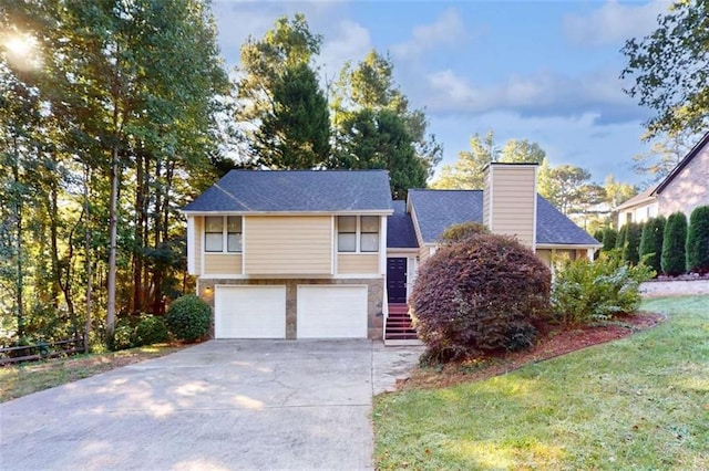 view of front of home featuring a garage and a front lawn