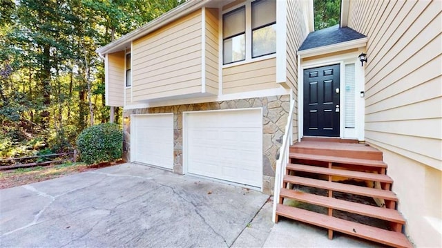 view of exterior entry with a garage