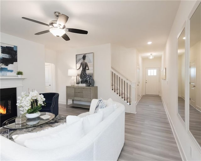 living room with hardwood / wood-style floors and ceiling fan