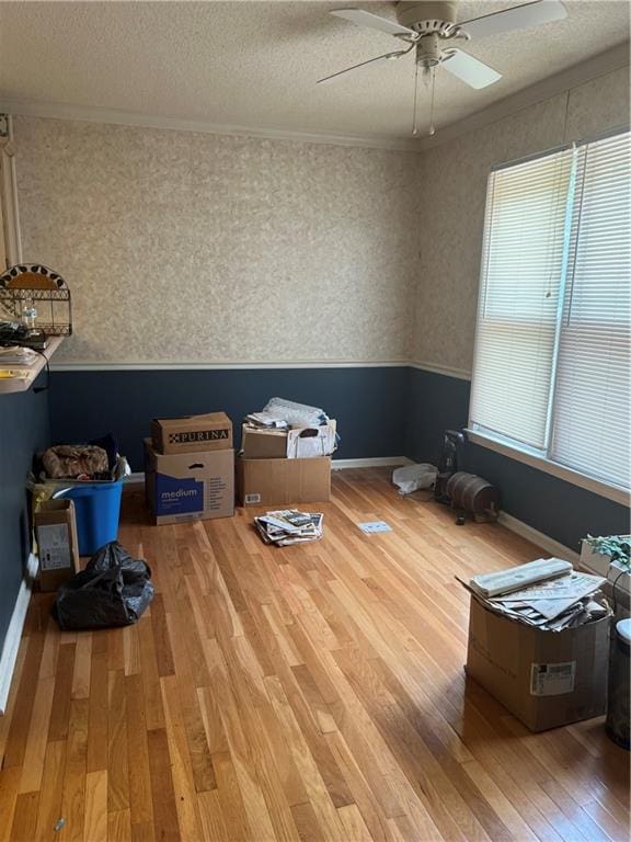 50 Ranger Rd SE, Cartersville, GA 30121 - empty room with hardwood / wood-style flooring, ceiling fan, a textured ceiling, crown molding, and wallpapered walls