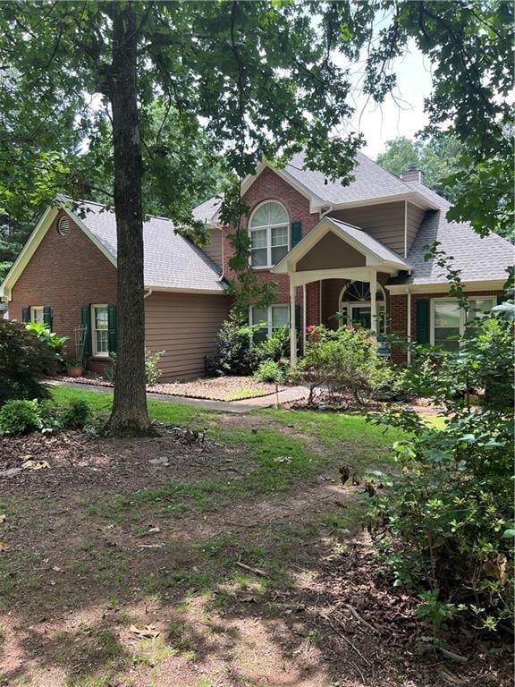 50 Ranger Rd SE, Cartersville, GA 30121 - view of front of property with brick siding, a chimney, and roof with shingles