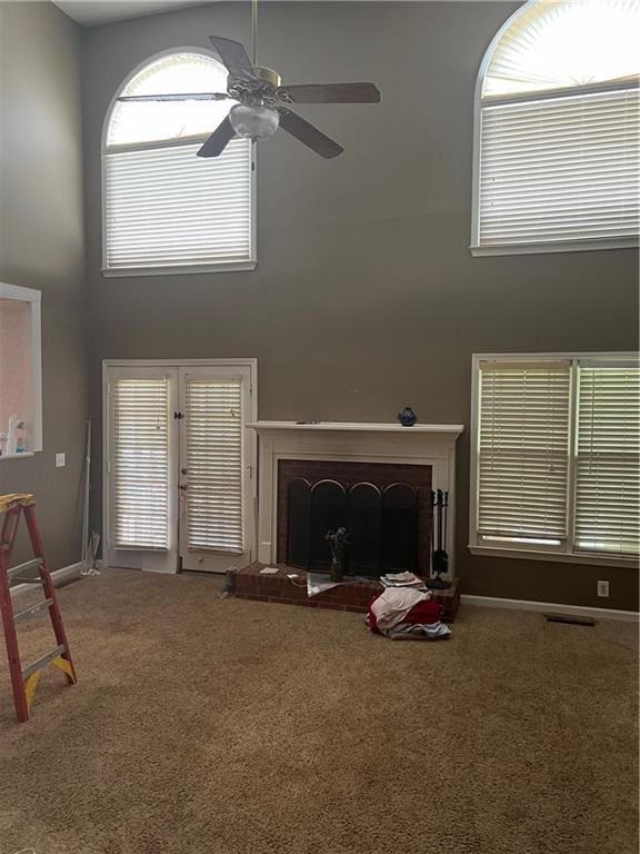 50 Ranger Rd SE, Cartersville, GA 30121 - carpeted living area featuring a towering ceiling, a fireplace, and ceiling fan