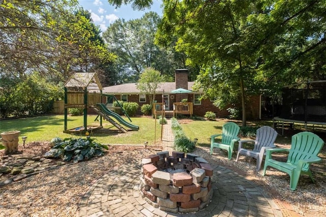 view of patio featuring a playground and a fire pit