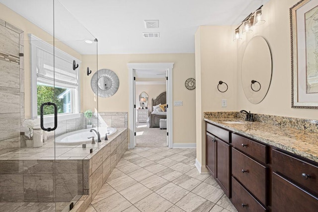 full bathroom with visible vents, vanity, ensuite bathroom, and a garden tub