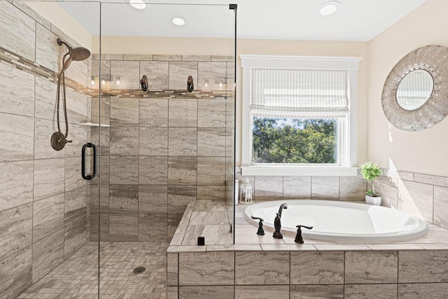 bathroom with a garden tub and a stall shower