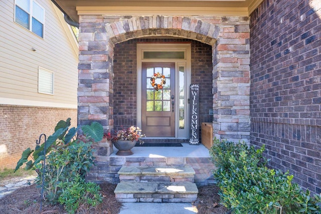 view of exterior entry with brick siding