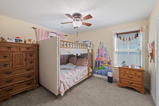 bedroom featuring light colored carpet, baseboards, and ceiling fan