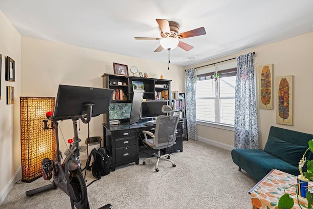 office area featuring light colored carpet, baseboards, and ceiling fan