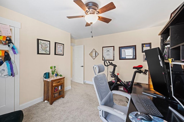 home office with light colored carpet, baseboards, and ceiling fan