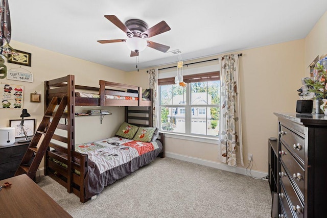 bedroom featuring visible vents, baseboards, carpet, and a ceiling fan