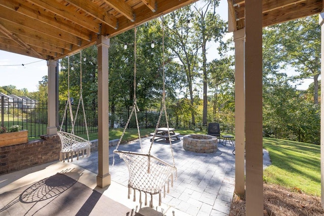 view of patio featuring a fire pit and fence