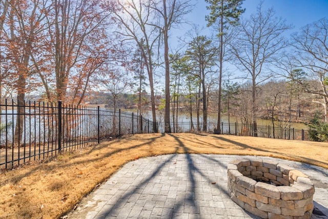 view of yard featuring a patio, a fenced backyard, and an outdoor fire pit