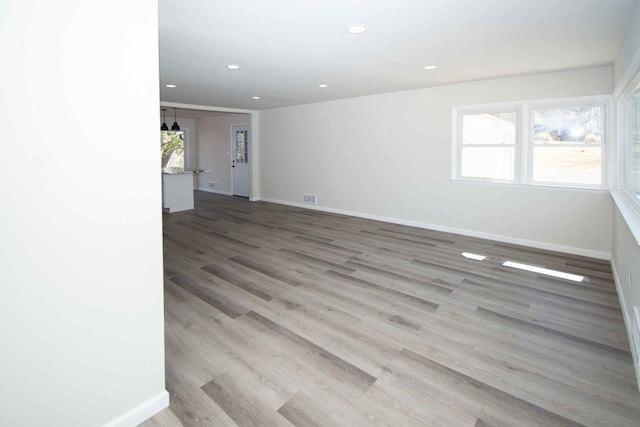 empty room with baseboards, recessed lighting, visible vents, and a healthy amount of sunlight