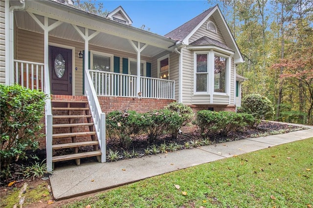 view of front facade with stairway and covered porch