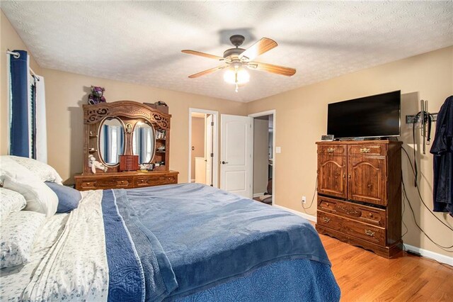bedroom with light wood-type flooring, baseboards, and a ceiling fan