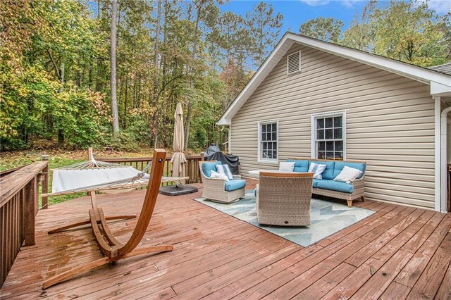 deck featuring grilling area and outdoor lounge area
