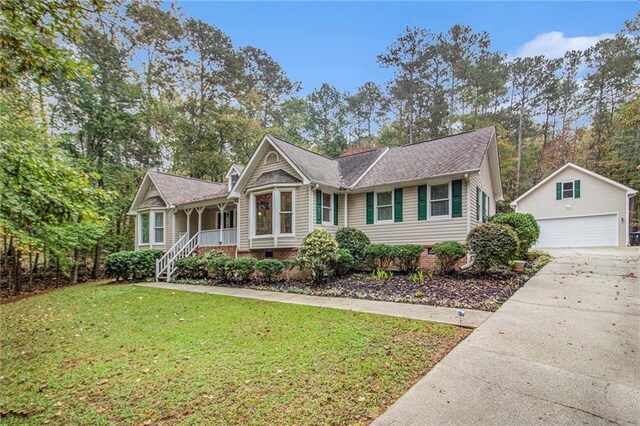ranch-style house featuring an outbuilding, a front lawn, a detached garage, and crawl space