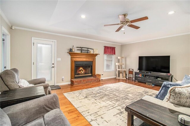 living room with recessed lighting, a fireplace, crown molding, ceiling fan, and wood finished floors