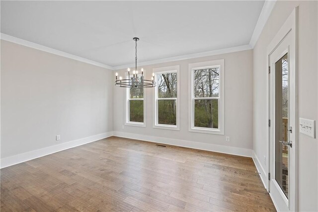 171 Blue Rider Trl, Hoschton, GA 30548 - unfurnished dining area featuring ornamental molding, a notable chandelier, and a healthy amount of sunlight