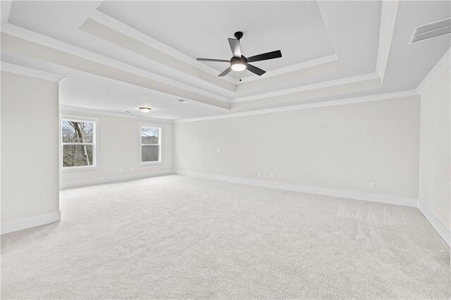 171 Blue Rider Trl, Hoschton, GA 30548 - spare room with a ceiling fan, light colored carpet, crown molding, visible vents, and a tray ceiling