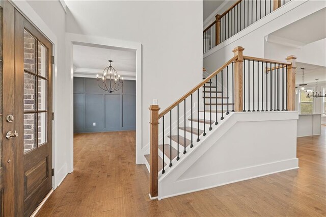 171 Blue Rider Trl, Hoschton, GA 30548 - stairway with baseboards, wood finished floors, and a chandelier