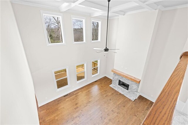 171 Blue Rider Trl, Hoschton, GA 30548 - unfurnished living room with coffered ceiling, a ceiling fan, beam ceiling, and a wealth of natural light