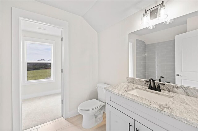 171 Blue Rider Trl, Hoschton, GA 30548 - bathroom featuring a shower, vanity, baseboards, toilet, and lofted ceiling