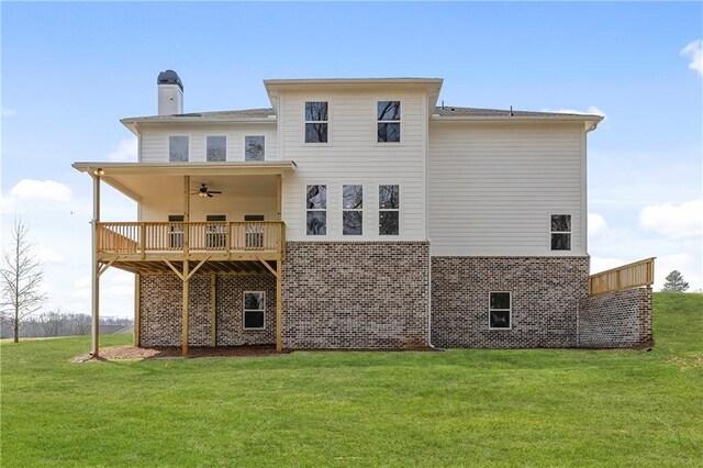 171 Blue Rider Trl, Hoschton, GA 30548 - rear view of property with ceiling fan, a deck, a chimney, brick siding, and a yard