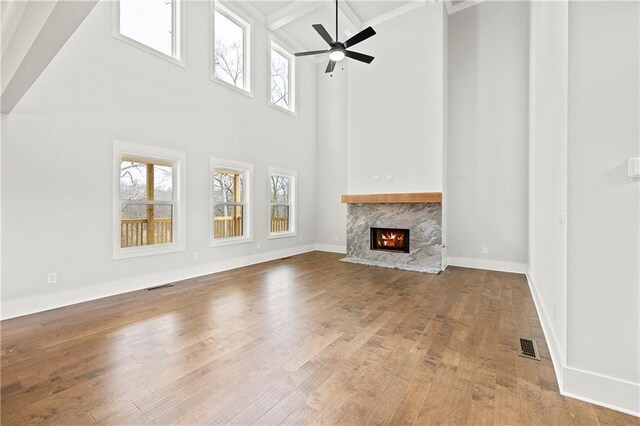 171 Blue Rider Trl, Hoschton, GA 30548 - unfurnished living room with plenty of natural light, a high ceiling, a fireplace, and visible vents