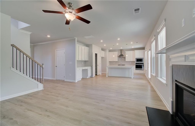 237 Chiswick Loop, Stockbridge, GA 30281 - unfurnished living room featuring baseboards, visible vents, stairs, ceiling fan, and a fireplace
