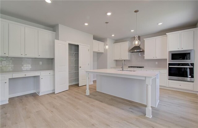 237 Chiswick Loop, Stockbridge, GA 30281 - kitchen with tasteful backsplash, a sink, light countertops, white cabinets, and appliances with stainless steel finishes