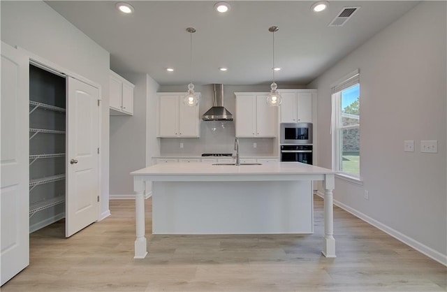 237 Chiswick Loop, Stockbridge, GA 30281 - kitchen with light countertops, wall chimney range hood, visible vents, stainless steel microwave, and wall oven