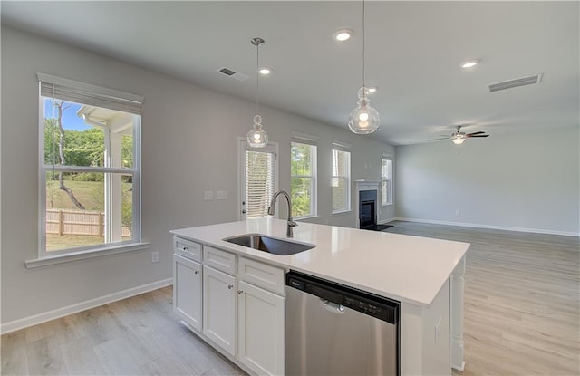 237 Chiswick Loop, Stockbridge, GA 30281 - kitchen featuring dishwasher, a glass covered fireplace, a sink, and visible vents