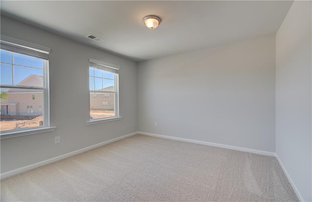 237 Chiswick Loop, Stockbridge, GA 30281 - spare room with carpet, visible vents, and baseboards