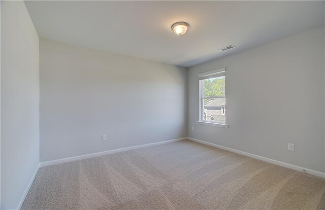 237 Chiswick Loop, Stockbridge, GA 30281 - spare room with light carpet, visible vents, and baseboards