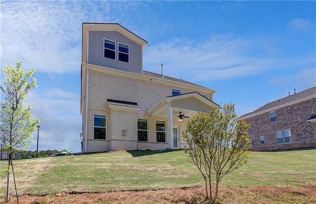 237 Chiswick Loop, Stockbridge, GA 30281 - back of property featuring a ceiling fan, brick siding, and a yard