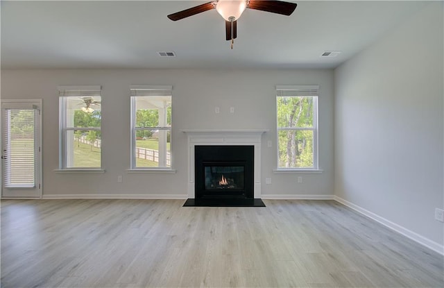 237 Chiswick Loop, Stockbridge, GA 30281 - unfurnished living room with wood finished floors, visible vents, a ceiling fan, and a wealth of natural light