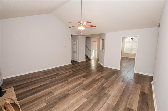 unfurnished living room featuring dark wood-type flooring, ceiling fan, and vaulted ceiling