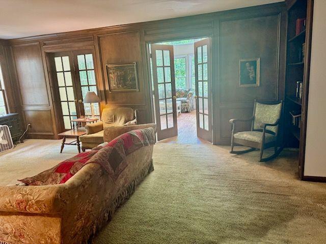 408 Hasty Trl, Canton, GA 30115 - living area featuring french doors, carpet flooring, and a decorative wall