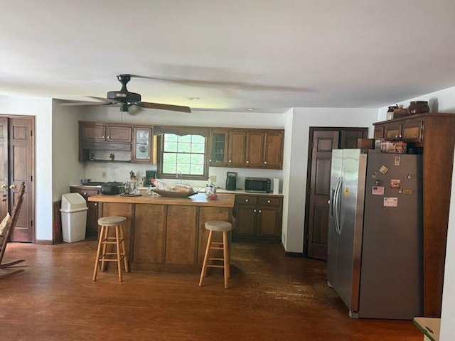 408 Hasty Trl, Canton, GA 30115 - kitchen with stainless steel appliances, dark wood-style floors, a kitchen breakfast bar, a ceiling fan, and a kitchen island