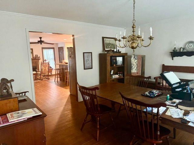 408 Hasty Trl, Canton, GA 30115 - dining room featuring a chandelier, wood finished floors, and crown molding