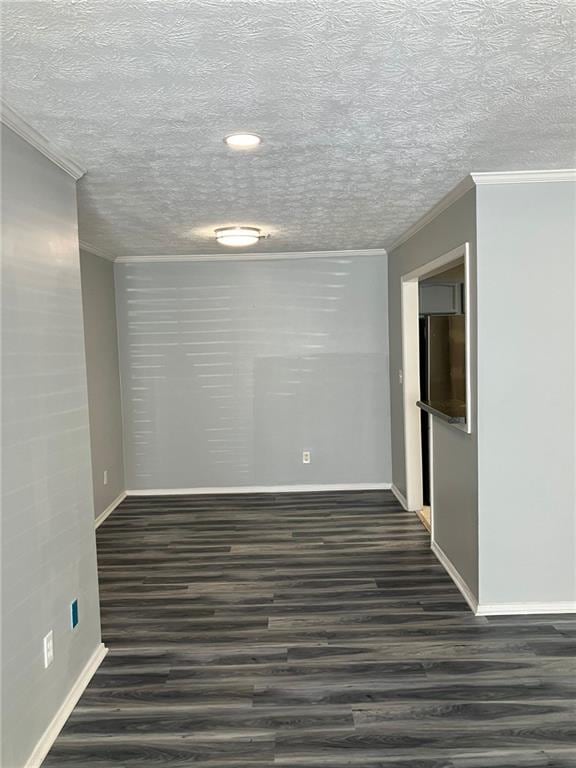 unfurnished room featuring dark hardwood / wood-style flooring and ornamental molding