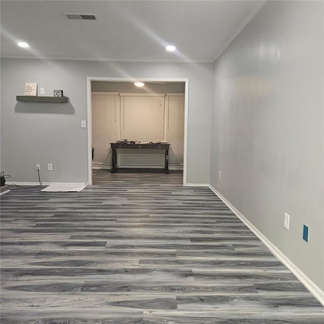 interior space with crown molding and dark hardwood / wood-style flooring