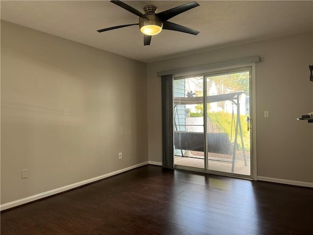 empty room with ceiling fan and dark wood-type flooring