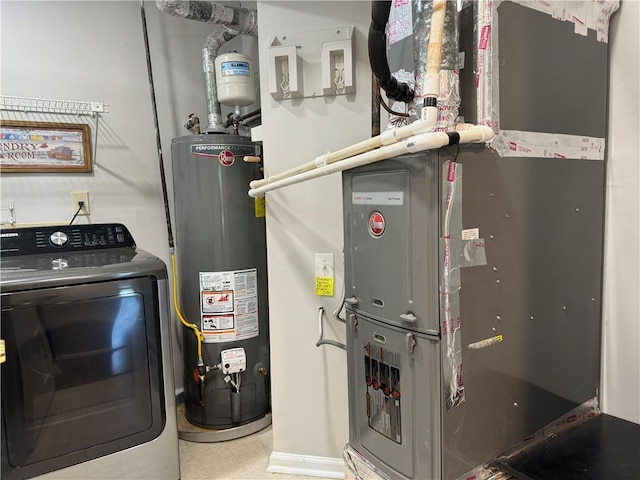 utility room featuring gas water heater, washer / clothes dryer, and heating unit