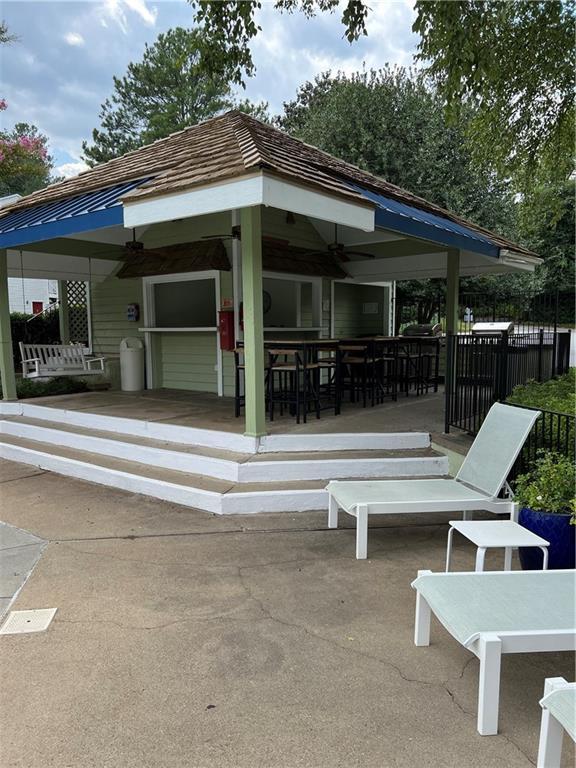 view of patio / terrace featuring a gazebo and ceiling fan