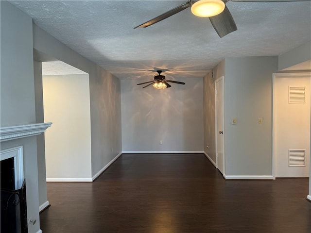 unfurnished living room featuring dark hardwood / wood-style floors and a textured ceiling