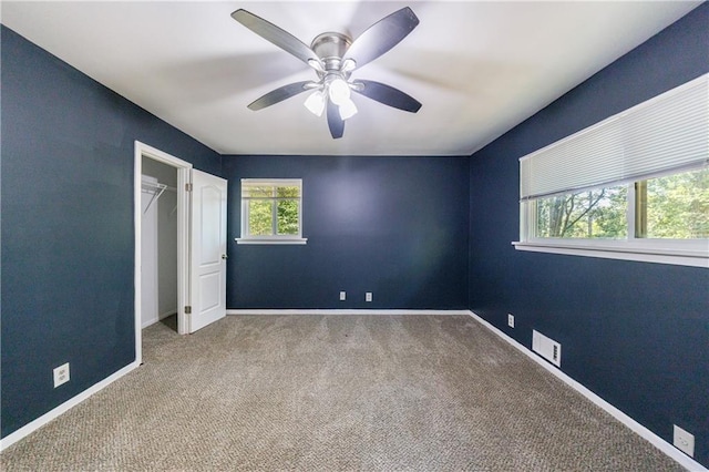 5287 Chantilly Ter, Atlanta, GA 30349 - unfurnished bedroom with ceiling fan, visible vents, baseboards, and carpet floors